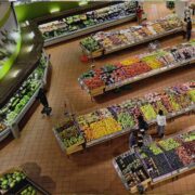 overhead view of supermarket produce section with shoppers.